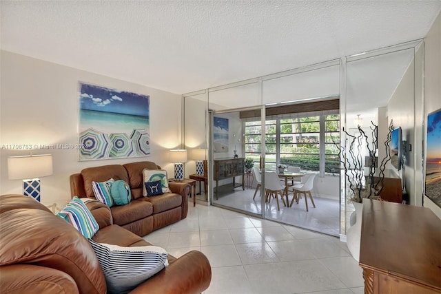 living room featuring light tile patterned flooring and a textured ceiling