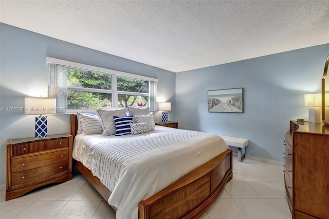 bedroom with a textured ceiling and light tile patterned flooring