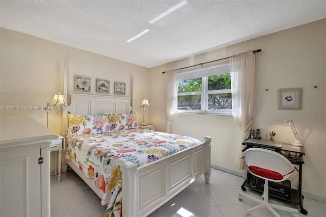 tiled bedroom with a textured ceiling