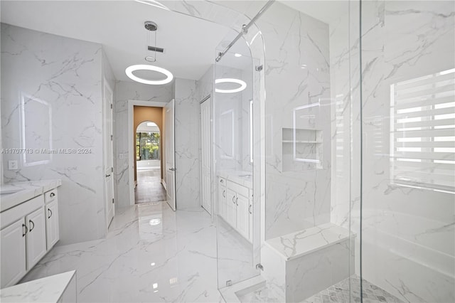 bathroom featuring vanity and a shower with shower door