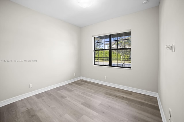 empty room with light hardwood / wood-style flooring