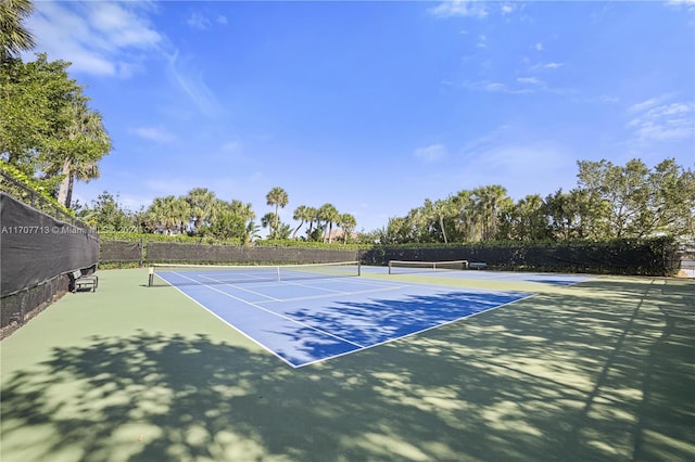 view of tennis court featuring basketball hoop