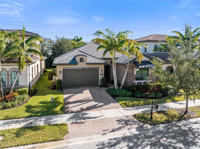 view of front of home featuring a front yard and a garage