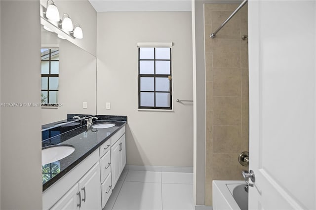 bathroom with tile patterned floors, vanity, and tiled shower / bath combo