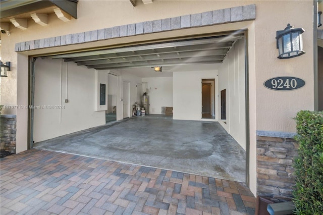 garage featuring electric panel, water heater, and a garage door opener