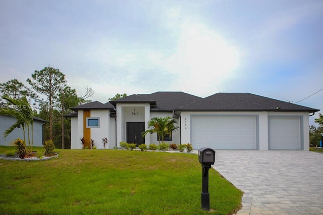 view of front facade featuring a front yard and a garage