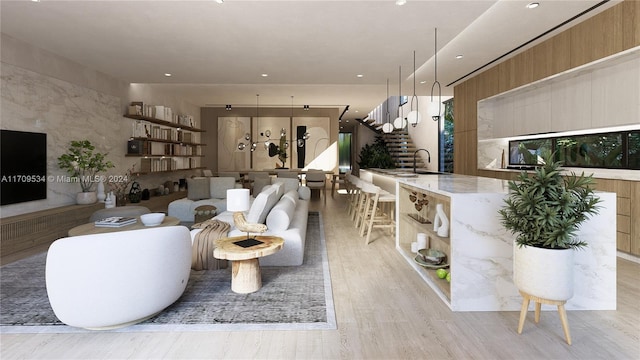 living room featuring sink and light hardwood / wood-style floors