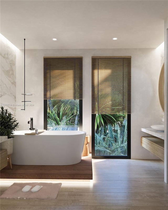 bathroom featuring hardwood / wood-style flooring and a tub