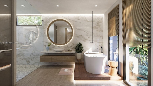 bathroom featuring a bathtub, vanity, tile walls, and hardwood / wood-style flooring