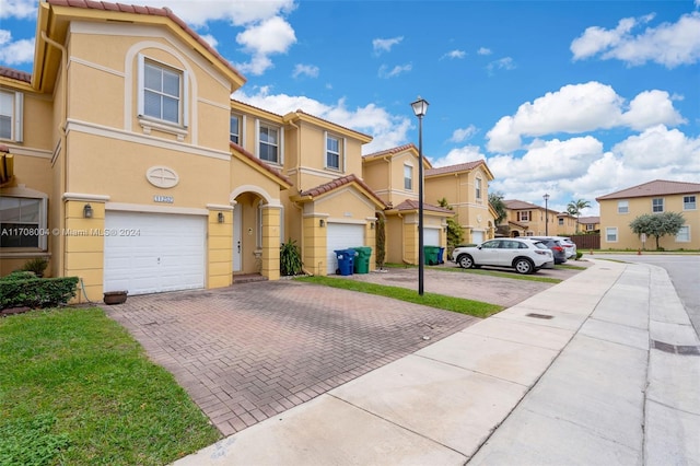 multi unit property featuring a garage