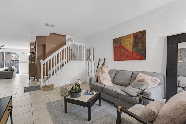 tiled living room featuring ceiling fan