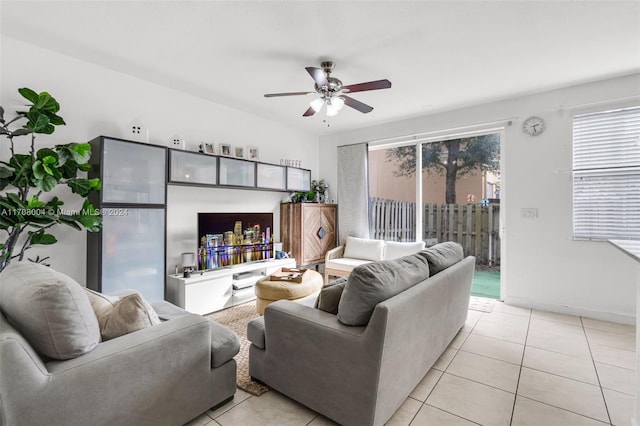 living room with ceiling fan and light tile patterned floors