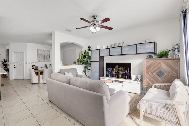 tiled living room featuring ceiling fan