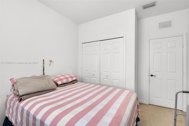 carpeted bedroom with a closet