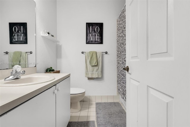 bathroom featuring tile patterned floors, vanity, and toilet