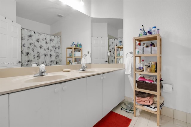 bathroom with tile patterned flooring, a shower with curtain, and vanity