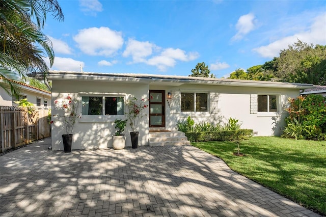 view of front of house with a front lawn and a patio area