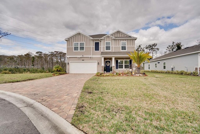 view of front of property with a garage and a front lawn