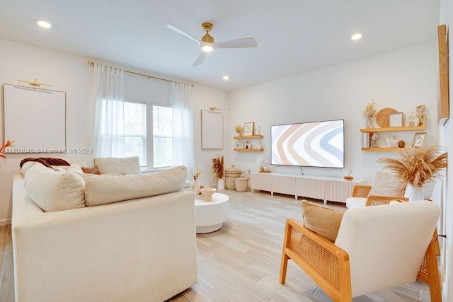 living room with hardwood / wood-style flooring and ceiling fan