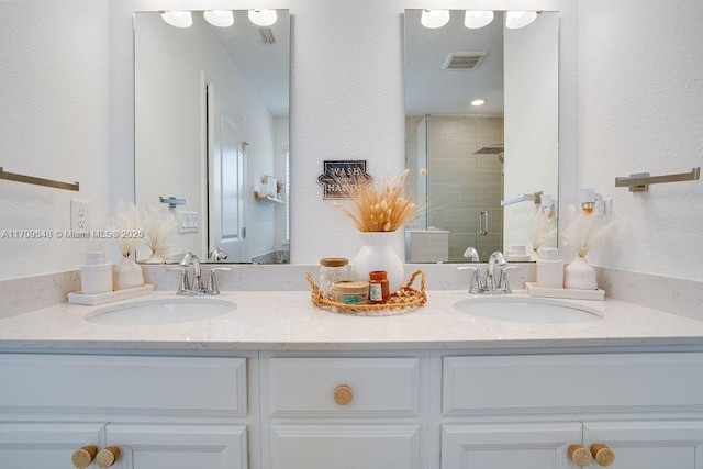 bathroom with vanity and a shower with shower door