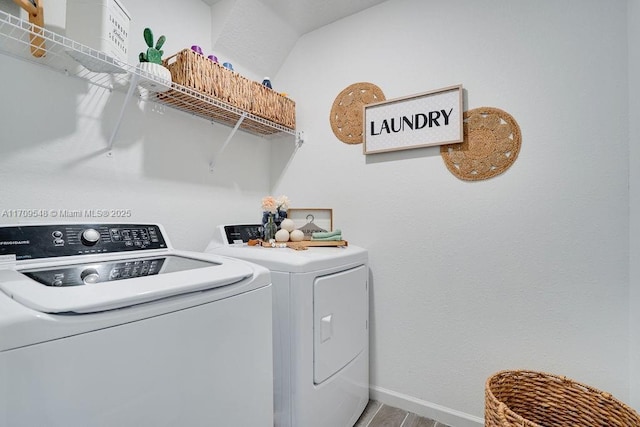 washroom featuring washing machine and dryer and wood-type flooring