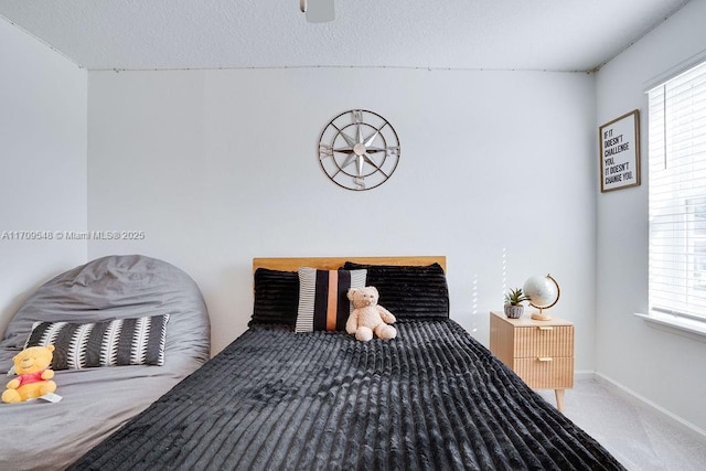 bedroom featuring carpet and a textured ceiling