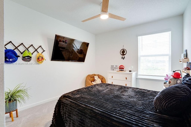 bedroom featuring ceiling fan and light carpet