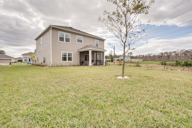 back of property featuring a lawn and a sunroom