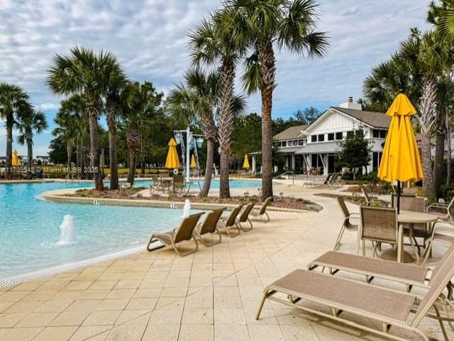 view of pool featuring pool water feature and a patio area