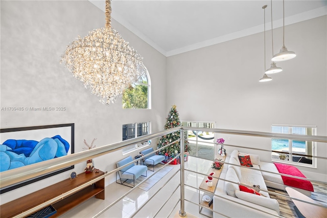 interior space featuring a wealth of natural light, a chandelier, and ornamental molding