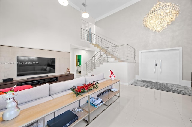 living room with an inviting chandelier, light tile patterned floors, and a towering ceiling