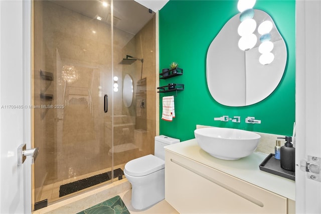 bathroom with toilet, vanity, tile patterned flooring, and a shower with door