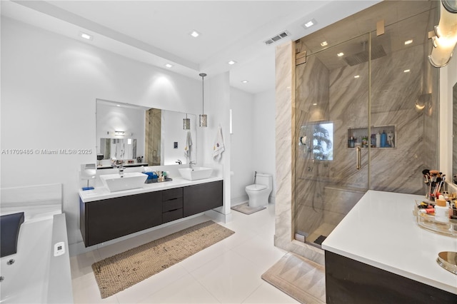 bathroom with a shower with shower door, vanity, tile patterned flooring, and toilet