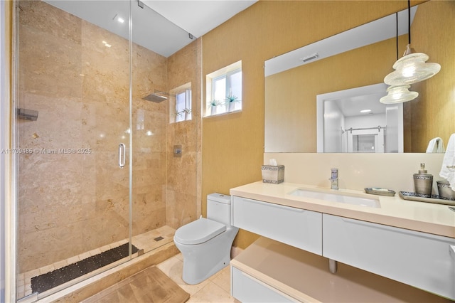 bathroom featuring toilet, tile patterned floors, walk in shower, and vanity