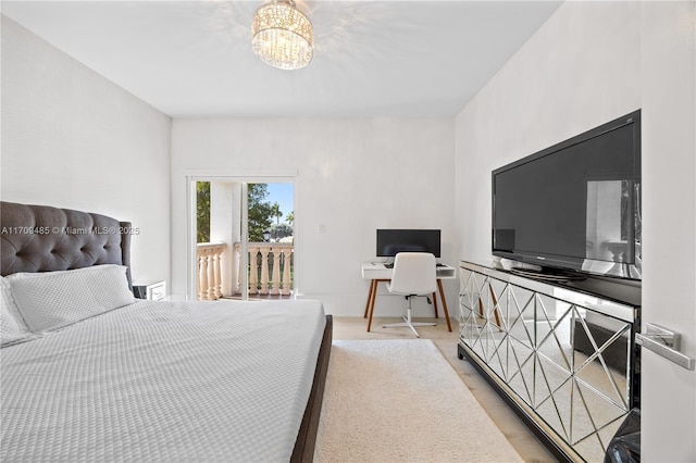 bedroom featuring access to exterior and a notable chandelier