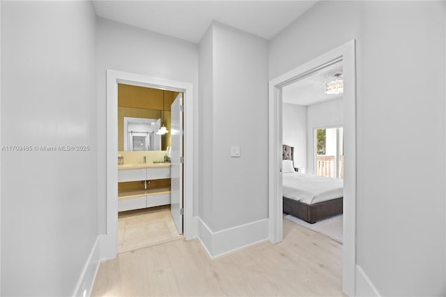 hallway with light hardwood / wood-style flooring