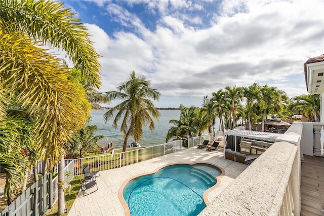 view of swimming pool featuring a water view and a patio