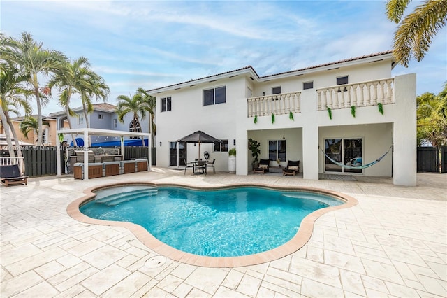 view of swimming pool featuring a bar and a patio