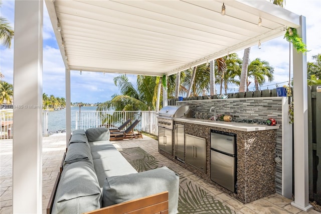 view of patio / terrace with an outdoor living space, a grill, area for grilling, and a water view