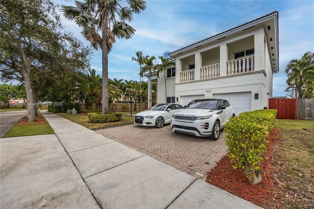 view of front facade with a balcony and a garage