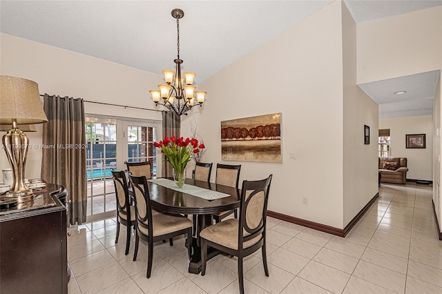 dining area with light tile patterned flooring, lofted ceiling, and an inviting chandelier