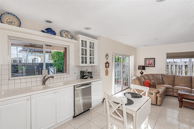 kitchen with white cabinetry, dishwasher, and plenty of natural light