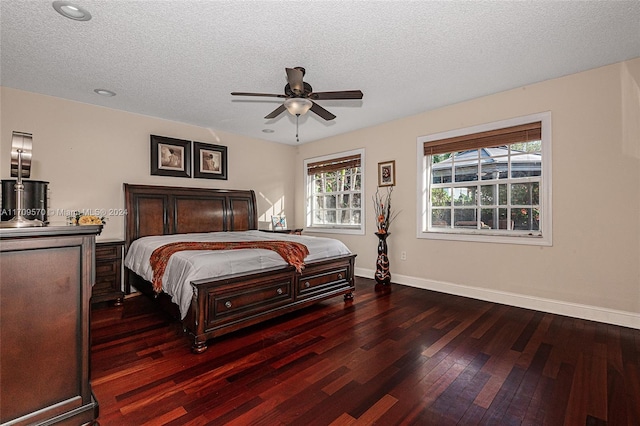 bedroom featuring a textured ceiling, dark hardwood / wood-style floors, and ceiling fan