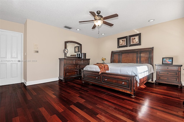 bedroom featuring ceiling fan, dark hardwood / wood-style flooring, and a textured ceiling