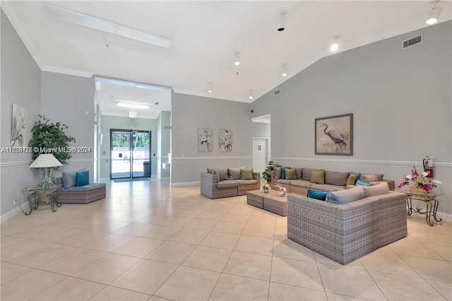 tiled living room featuring lofted ceiling and ornamental molding