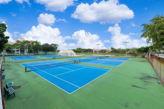 view of tennis court with basketball hoop