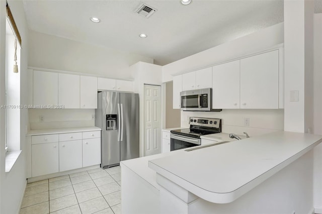 kitchen with white cabinetry, kitchen peninsula, and appliances with stainless steel finishes