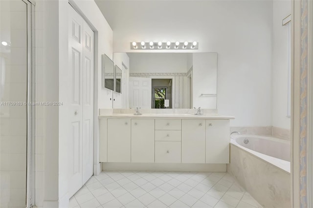 bathroom with tile patterned flooring, vanity, and shower with separate bathtub