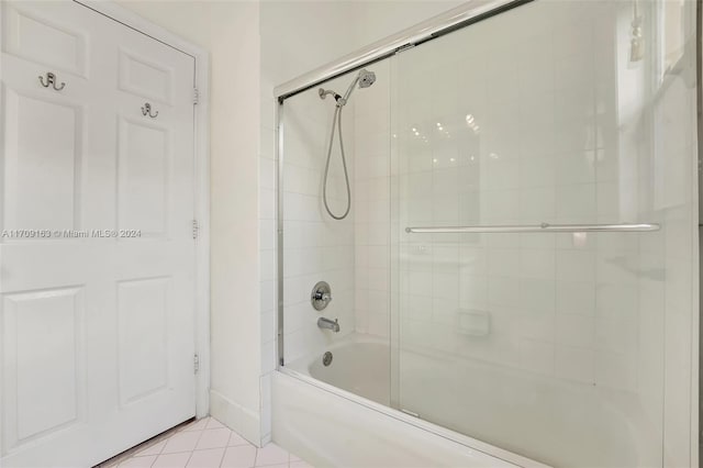 bathroom featuring tile patterned flooring and combined bath / shower with glass door