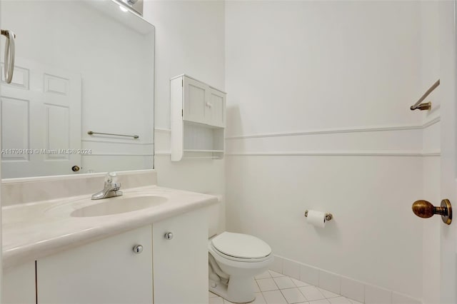 bathroom featuring tile patterned flooring, vanity, and toilet